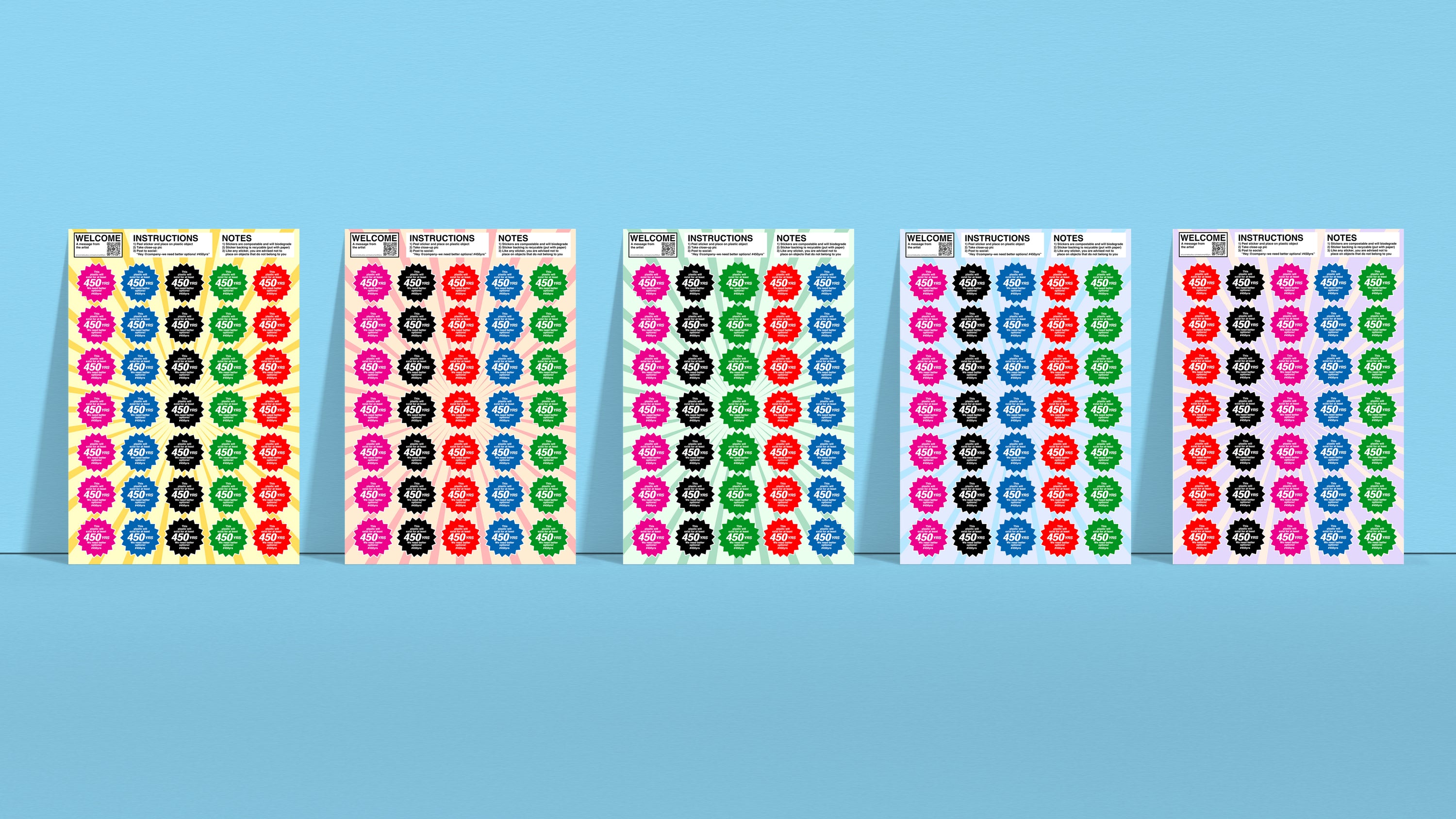 Photograph showing five 8.5 inch by 12.25 inch sticker sheets side by side with different color backgrounds. Each sheet contains 35, multi-colored, starburst-shaped stickers