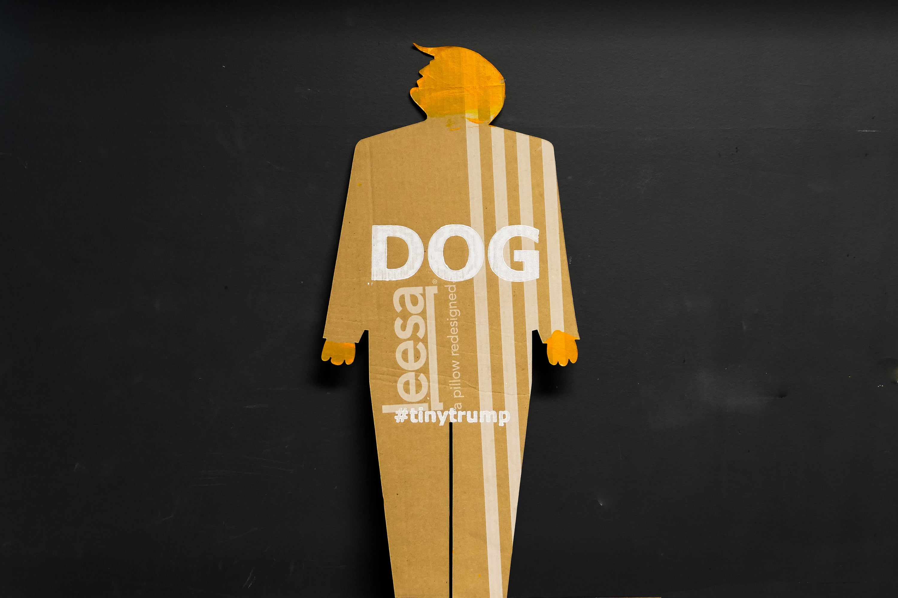 A two foot tall, cardboard tiny trump with the slogan "Dog"