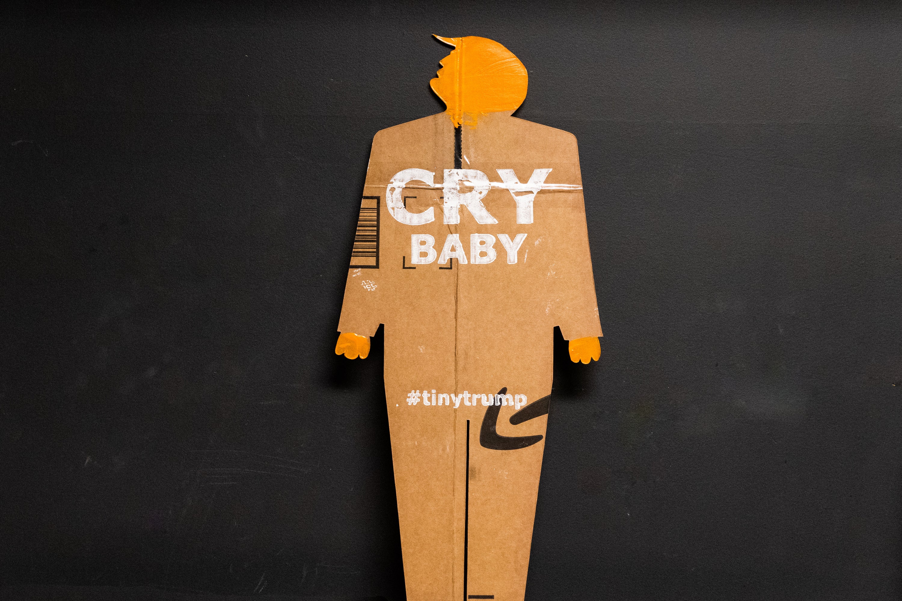 A two foot tall, cardboard tiny trump with the slogan "Cry Baby"