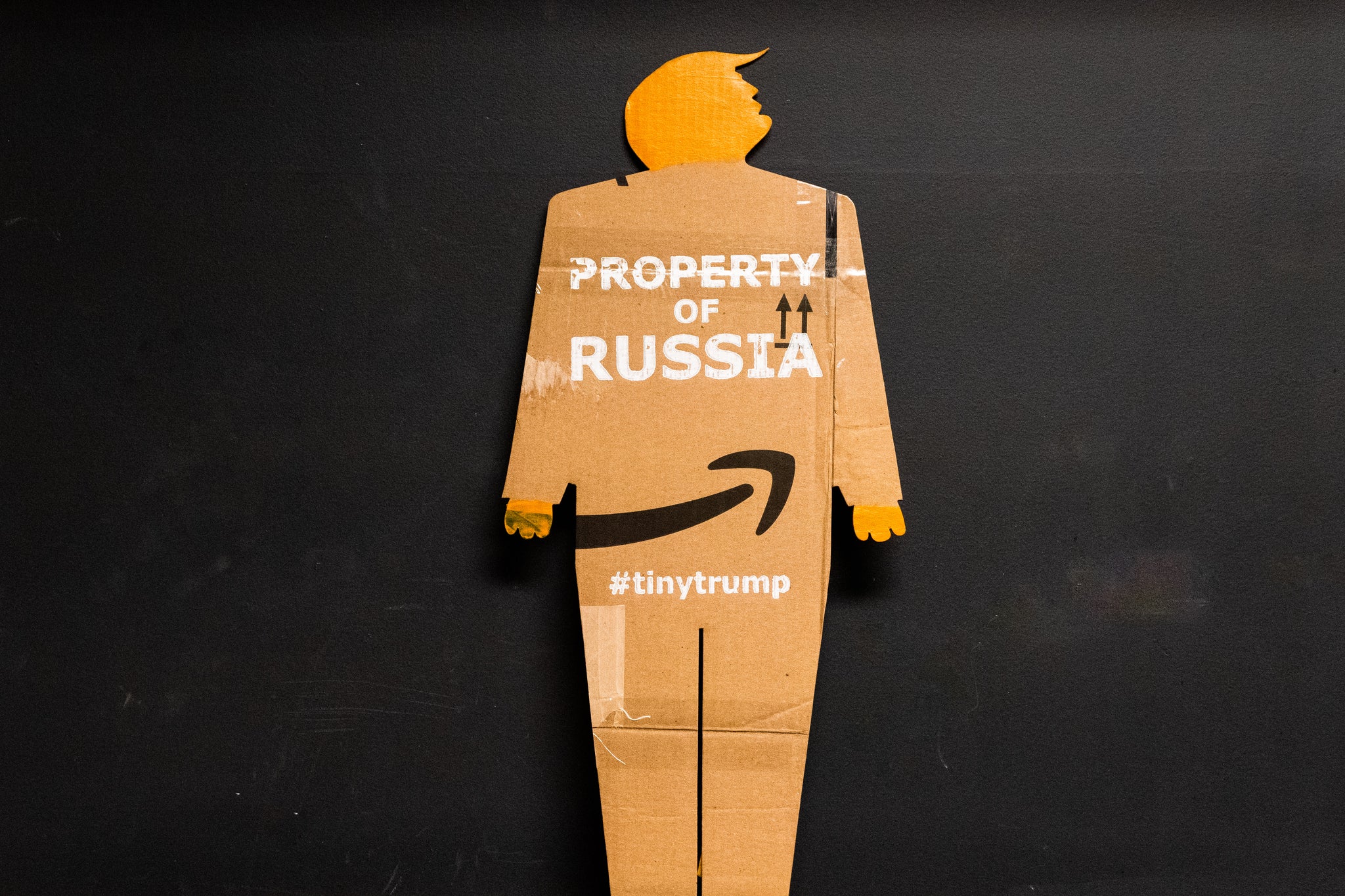 A two foot tall, cardboard tiny trump with the slogan "Property of Russia"