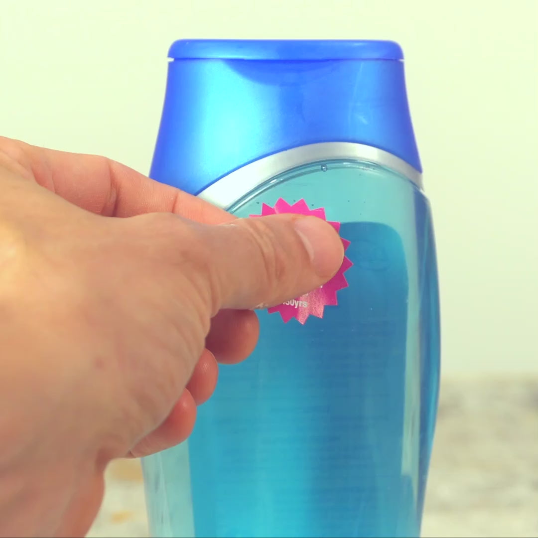 Video showing someone putting a "450YRS sticker" on a plastic bottle, taking a pic of it with their phone, and composing a social media post asking the corporation for better packaging options. The text on the sticker reads: "This plastic will exist for at least 450 years. We need better options! #450yrs"
